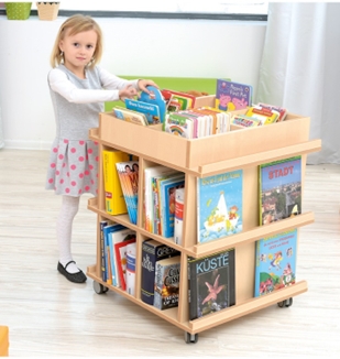 Mädchen am Bücherregal stehend mit Buch