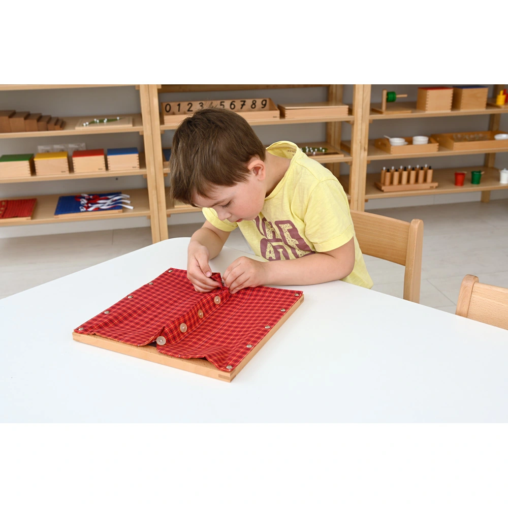 Montessori-Frühförderung: Kind beschäftigt sich selbstständig mit einem Verschlussspiel